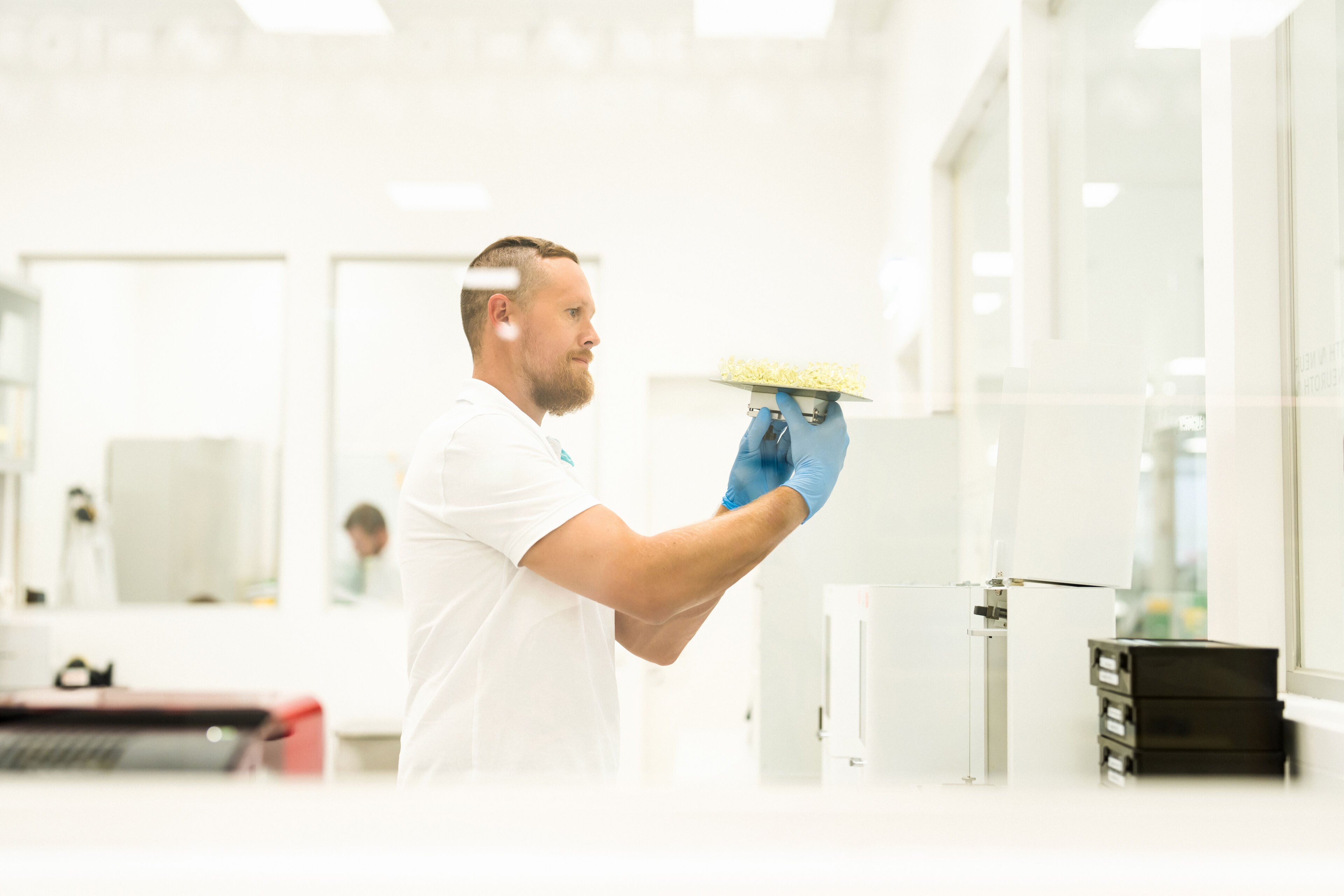 Techniker überprüft 3D-gedruckte individuell angepasste Gehörschutzlösungen – Präziser Fertigungsprozess für maßgeschneiderten Gehörschutz mit höchster Passgenauigkeit.